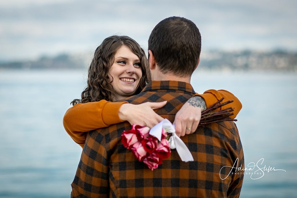 A man and woman look into each other's eyes after getting engaged on a holiday, moment captured by Washington wedding photographer Adina Stiles.