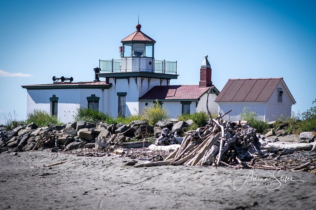 A picturesque lighthouse along the beach in Discovery Park, Seattle, which is also one of the best photo spots in Puget Sound.